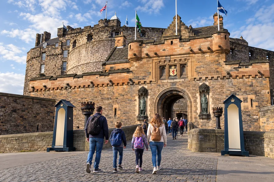A family exploring the stone entrance to Edinburgh Castle